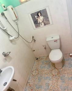 a bathroom with a white toilet and a sink at Tribal Pai in Pai