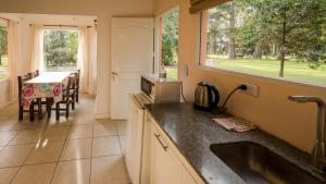 a kitchen with a sink and a table and a window at NomeolvidesMás in Tandil