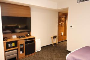 a hotel room with a bed and a television at KEIKYU EX INN Haneda Innovation City in Tokyo