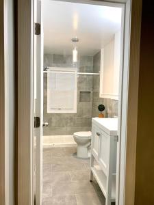 La salle de bains est pourvue de toilettes et d'un lavabo. dans l'établissement The Roulette Duplex- With Private Yard & Parking, Minutes From Falls & Casino by Niagara Hospitality, à Niagara Falls