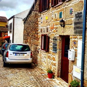 a car parked in front of a stone building at Casa Dr. Saba in Belmonte