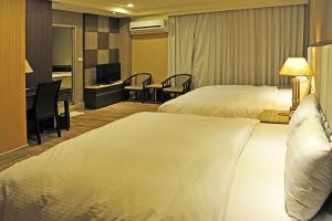 Postel nebo postele na pokoji v ubytování Maple Hotel
