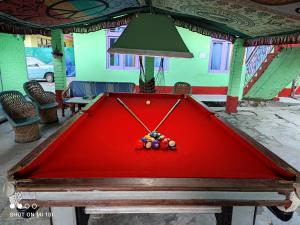 una mesa de billar roja con bolas encima en Dream Valley Home Stay en Kasol