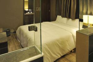 Postel nebo postele na pokoji v ubytování Maple Hotel
