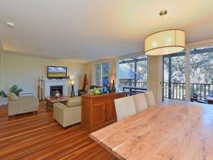 a dining room and living room with a dining table at Villa 3br Vista Villa located within Cypress Lakes Resort in Pokolbin