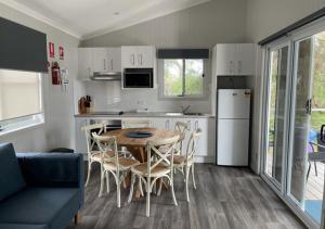 a kitchen and dining room with a table and chairs at NRMA Shellharbour Beachside Holiday Park in Shellharbour