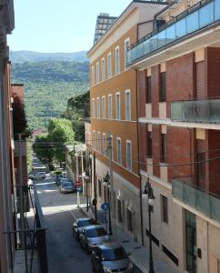 a city street with cars parked on the side of a building at Il Sogno di Hypnos in LʼAquila