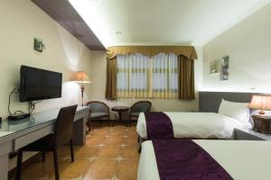 Telewizja i/lub zestaw kina domowego w obiekcie Kending Kaying Hotel