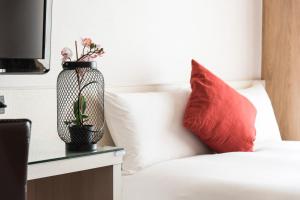 Łóżko lub łóżka w pokoju w obiekcie Kending Kaying Hotel
