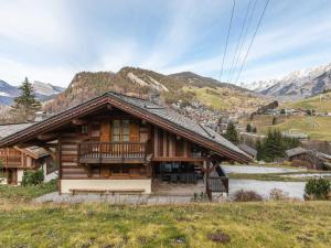 a wooden house with a balcony on a hill at Chalet La Clusaz, 5 pièces, 8 personnes - FR-1-304-110 in La Clusaz