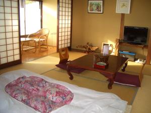 Posteľ alebo postele v izbe v ubytovaní Tomitaya Ryokan Bekkan
