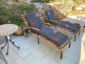 a pair of chairs and a table on a patio at Apartments Vila Vino in Sveta Nedelja