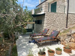 a group of chairs sitting on a patio at Apartments Vila Vino in Sveta Nedelja
