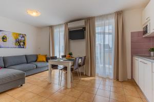 a living room with a couch and a table at Apartments Dolac in Nerezine