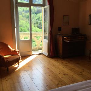 an open door to a room with a window and a couch at Villa Meyriem in Mouthier-Haute-Pierre +120 photos