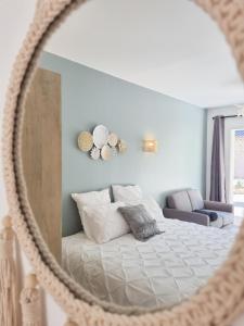 a bedroom with a bed and a mirror at Cosy en Provence - Piscine chauffée in Pernes-les-Fontaines