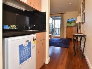 a kitchen with a sink and a dishwasher at Villa Spa Executive 1br Pinot located within Cypress Lakes Resort in Pokolbin