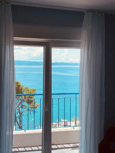 a view of the ocean from a bedroom window at Hotel Elu Iris in Split
