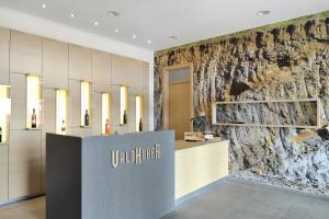 a lobby of a store with a stone wall at Vino Valdhuber Apartments in Svečina