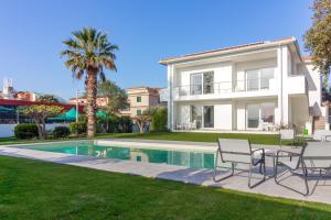 a villa with a swimming pool and a house at Villa Mary in Olbia