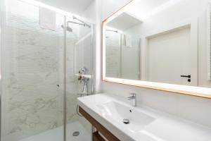 a bathroom with a sink and a glass shower at Bel Mare Resort Apartment with Parking by Renters in Międzyzdroje