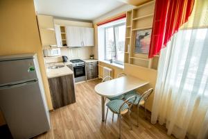 a small kitchen with a table and chairs in a room at Cietokšņa iela 55a in Daugavpils
