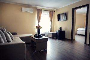 a living room with a couch and a table at London Apartments Vaslui in Vaslui