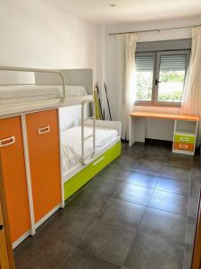 a bedroom with two bunk beds and a desk at APARTAMENTO JMHR 4 in Benajarafe