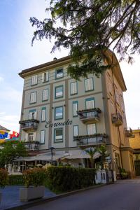 a large building with a sign on the side of it at Hotel Ristorante Eurossola in Domodossola