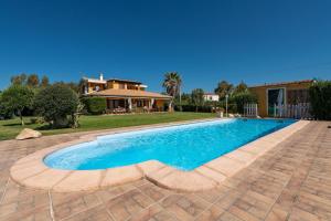 a swimming pool in a yard with a house at Masone Murgioni in Castiadas