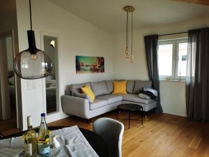 a living room with a couch and a table at Uferloft in Immenstaad am Bodensee