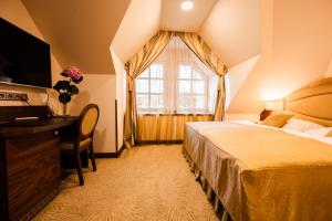 a hotel room with a bed and a window at Imperial Casino Strazny Hotel in Strážný