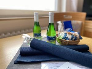 two bottles of wine and a basket on a table at Haus Iderhoff- Wohnung 5 in Norderney