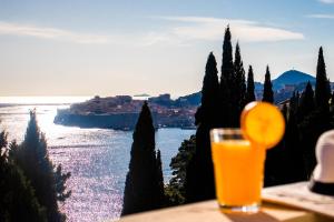 a glass of orange juice sitting on top of a table at Villa Odak in Dubrovnik