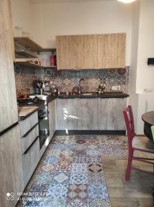 a kitchen with a tile floor and a counter top at La casa di Giulio - holiday home in Isola delle Femmine