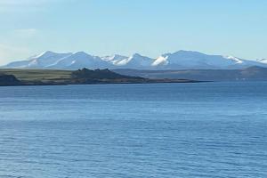 a large body of water with mountains in the background at Ferry View in Largs