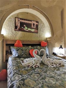 a bedroom with two swans on top of a bed at Nox Cave Hotel in Nevşehir