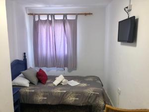 A bed or beds in a room at Pensión Playa