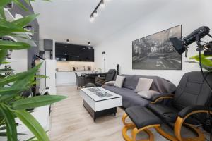 a living room with a couch and a table at Platinium Apartment by Renters Prestige in Rewal