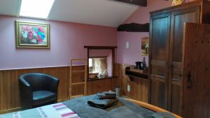 a bedroom with a bed and a chair and a mirror at La Grange de Champagnac in Yvrac-et-Malleyrand