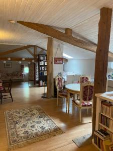 a room with a table and chairs and a book shelf at Villa Toulousaine in Grisolles