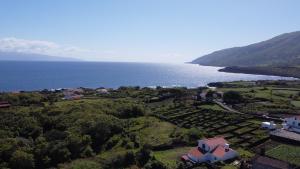 an aerial view of a resort and the ocean at The House in São Roque do Pico