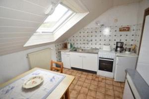 a kitchen with a skylight and a table and a sink at Ferienwohnung Treutlein in Thüngersheim