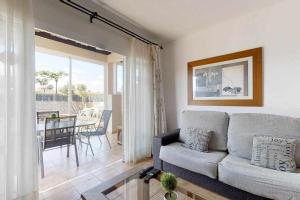 a living room with a couch and a table at Anju villasVILLA MARGA VILLA AT 100 METERS FAR OF THE BEACH in Corralejo