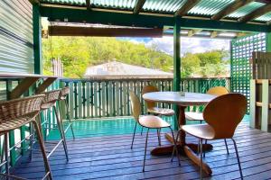 a porch with a table and chairs on a deck at Wilde Flour in Stratford