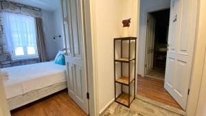 a bedroom with a bed and a book shelf at Oberj d'Azur Alaçatı in Alaçatı