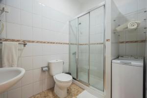 a bathroom with a toilet and a glass shower at Eurosant Playas in Playa de San Juan