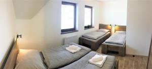 Posteľ alebo postele v izbe v ubytovaní Horské apartmány Na Pastvinách