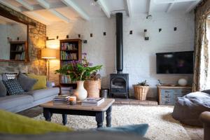 a living room with a couch and a fireplace at Little Underhill in Oswestry