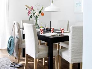 a dining room with a black table and white chairs at Holiday home- Bungalow in Loosdrecht +27 photos